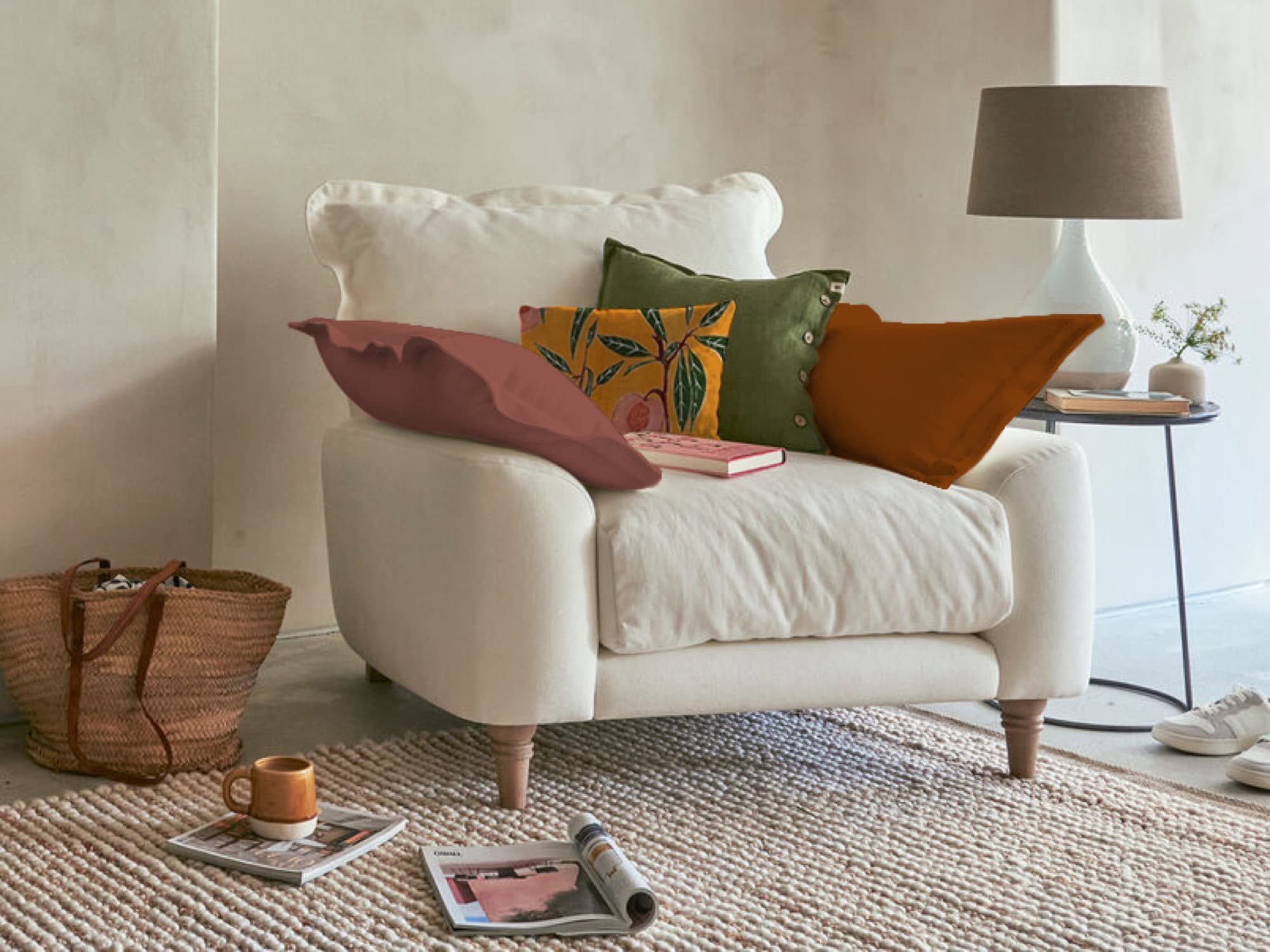 White summer-palette armchair with blue and green cushions