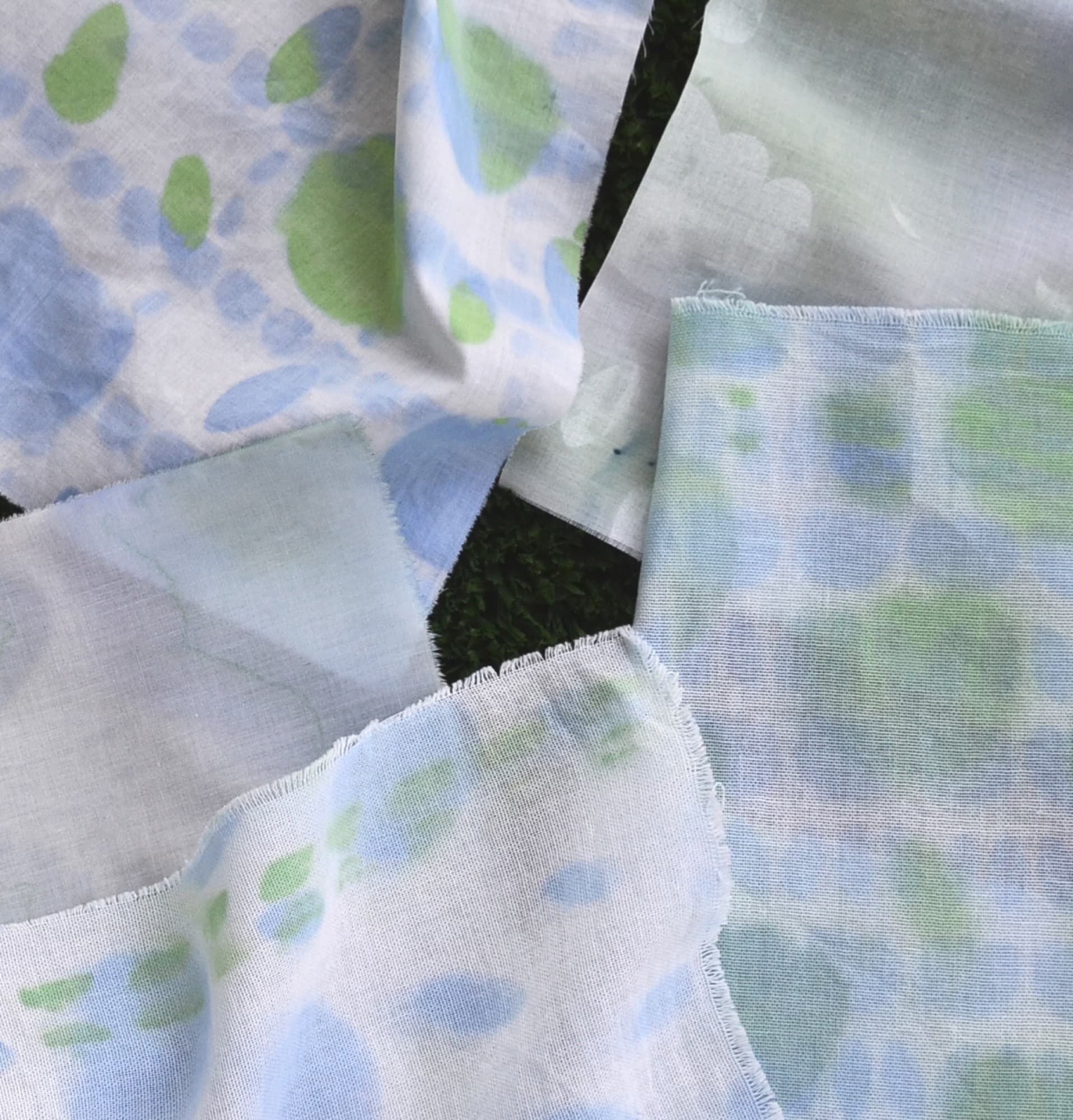Overlapping printed fabric swatches in green and blue